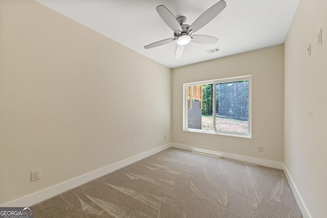 unfurnished room featuring carpet, baseboards, visible vents, and a ceiling fan