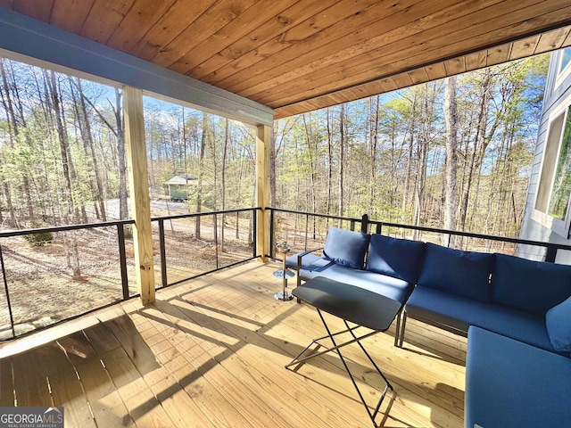 unfurnished sunroom with wood ceiling