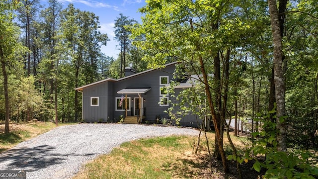 view of front of house featuring driveway and a chimney