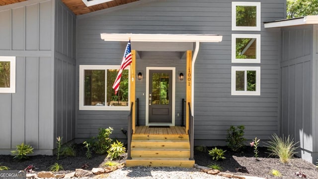 view of exterior entry featuring board and batten siding