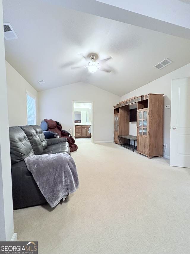 carpeted living room featuring ceiling fan and lofted ceiling