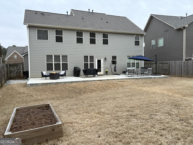 rear view of property featuring a patio and a yard