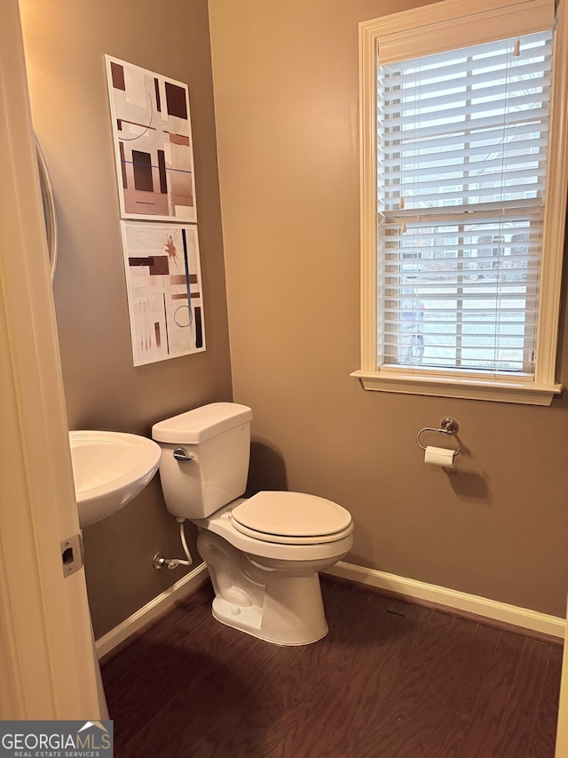 bathroom featuring plenty of natural light, wood-type flooring, toilet, and sink