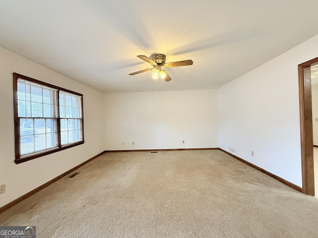 carpeted empty room with ceiling fan