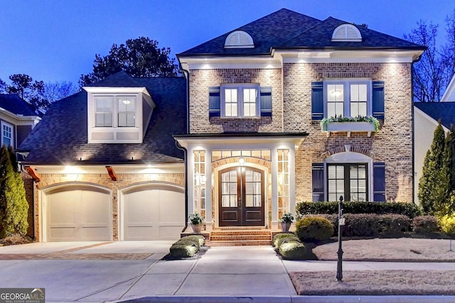 view of front of property with a garage and french doors