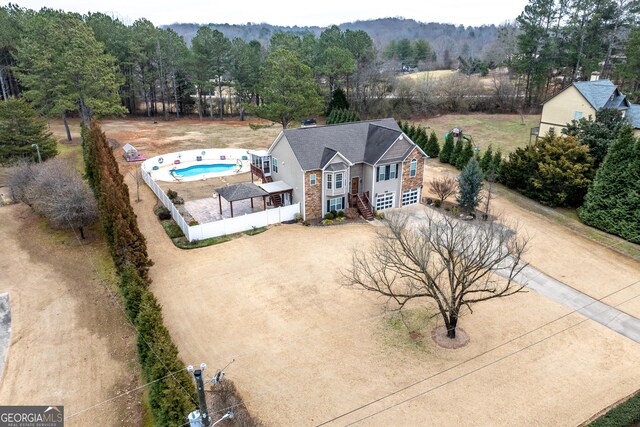 view of front of house featuring a garage and a shed