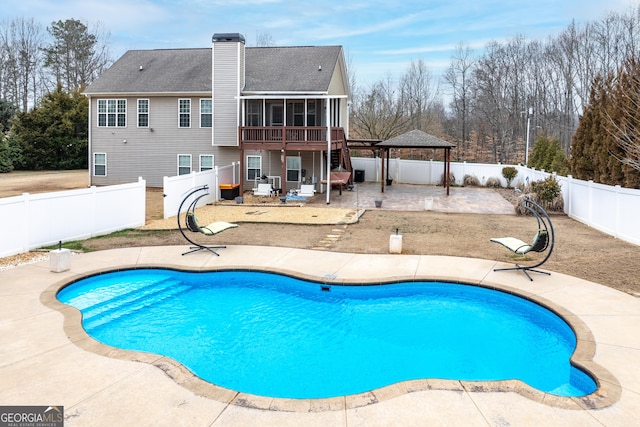 view of swimming pool featuring a gazebo, a patio area, a fenced backyard, and a sunroom