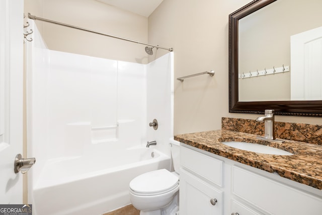 bathroom featuring tub / shower combination, vanity, and toilet