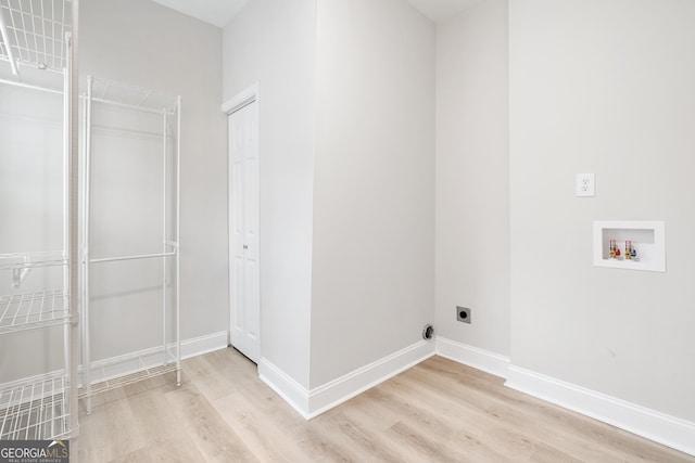 washroom featuring hookup for a washing machine, hookup for an electric dryer, laundry area, baseboards, and light wood-type flooring