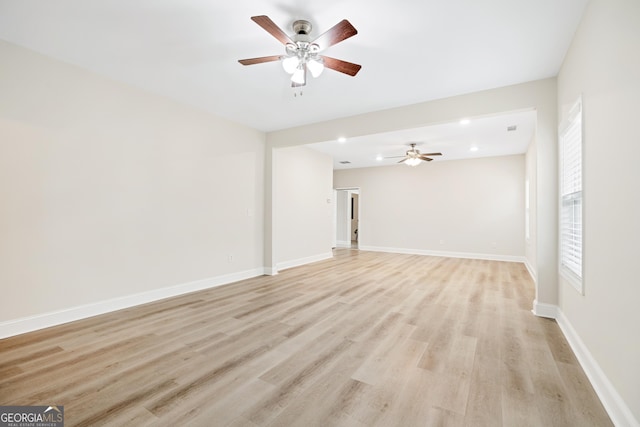 unfurnished living room with light wood-style flooring, baseboards, ceiling fan, and recessed lighting