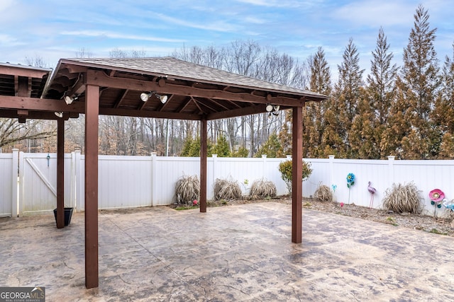 view of patio / terrace featuring a gate, a fenced backyard, and a gazebo