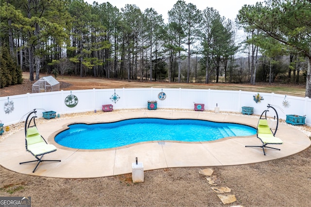 view of pool with a fenced in pool, a fenced backyard, and a patio