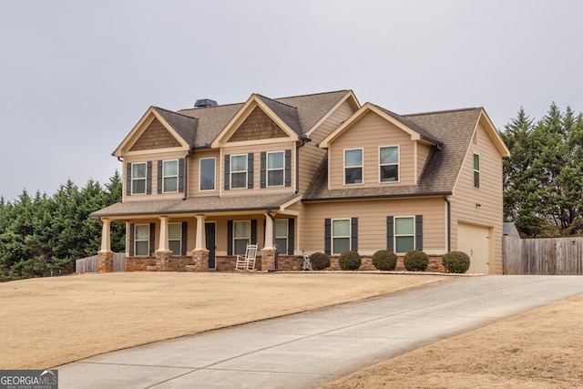 craftsman inspired home with a garage and covered porch