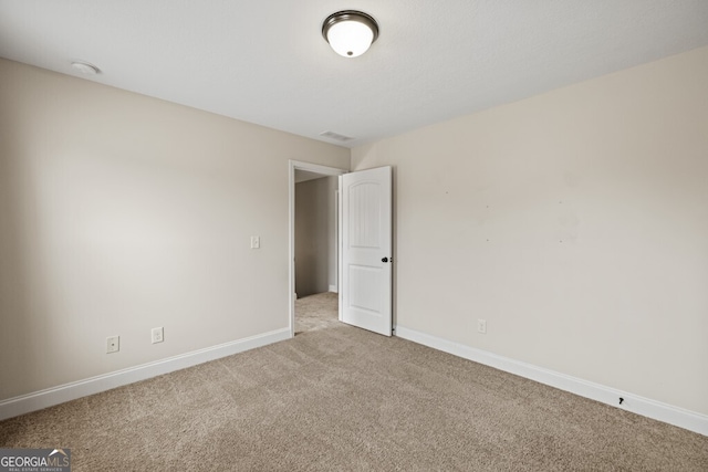 spare room with light carpet