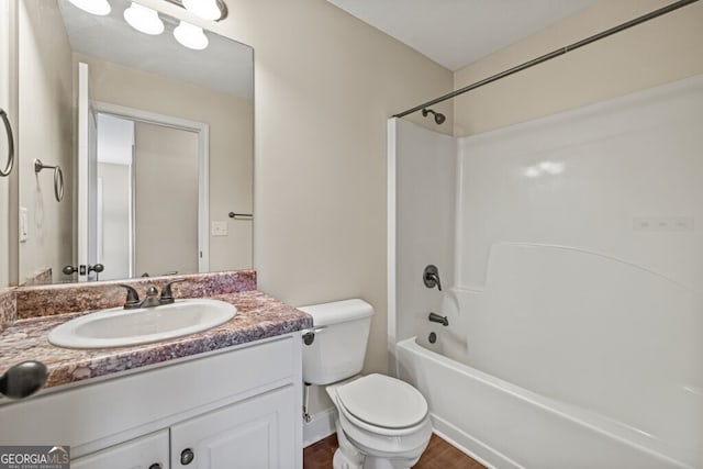 full bathroom featuring shower / washtub combination, wood-type flooring, toilet, and vanity