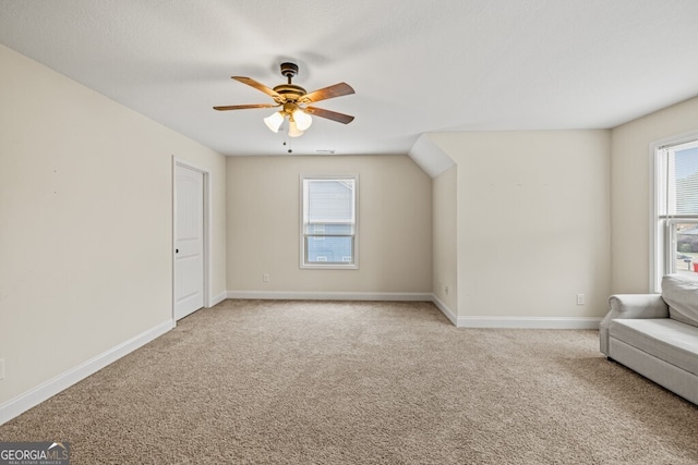 unfurnished room with ceiling fan and carpet