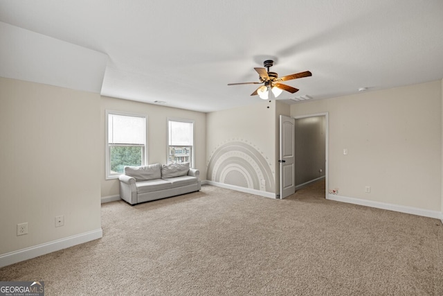 unfurnished living room with ceiling fan and light carpet