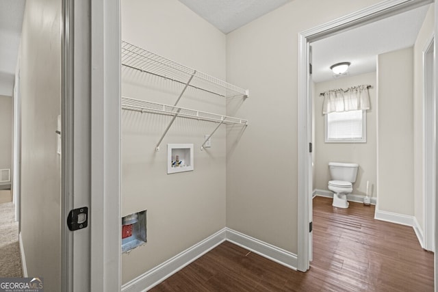 laundry area featuring hookup for a washing machine and dark hardwood / wood-style flooring