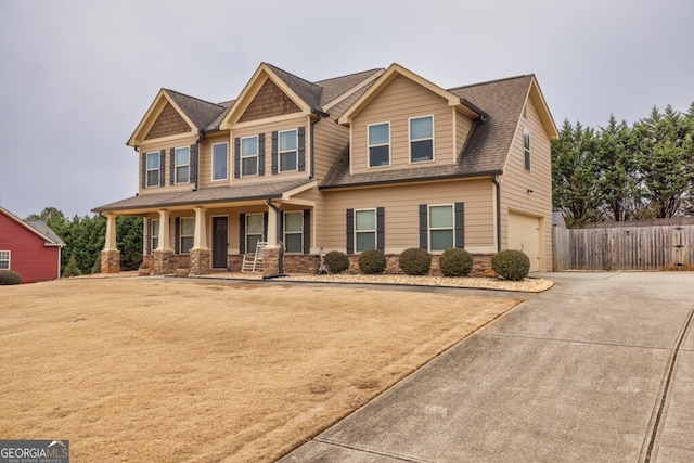 craftsman inspired home with a garage and covered porch