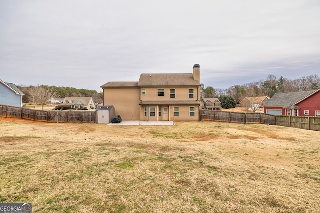 rear view of house featuring a patio area and a yard