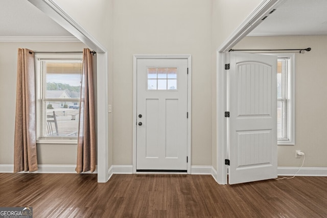 entryway with crown molding and dark wood-type flooring