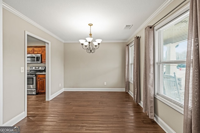 unfurnished dining area featuring dark hardwood / wood-style floors, ornamental molding, and an inviting chandelier