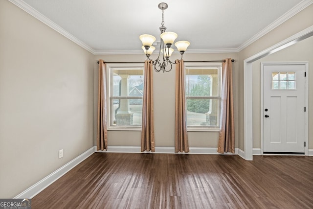 unfurnished dining area with dark hardwood / wood-style floors, crown molding, and a chandelier