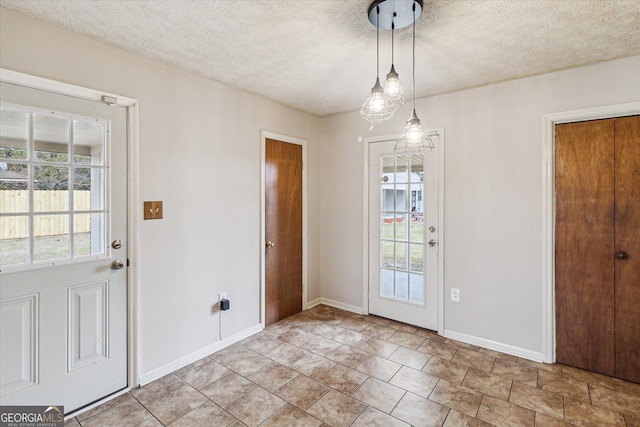 doorway featuring a textured ceiling