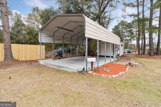 view of vehicle parking with a lawn and a carport