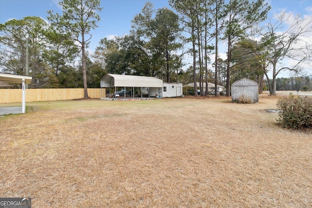 view of yard featuring a carport and a storage shed