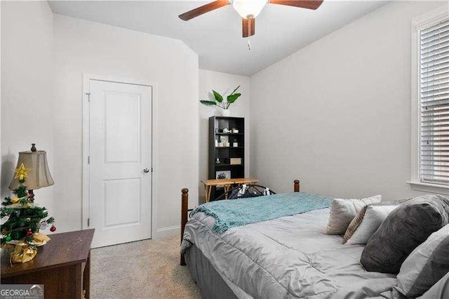 bedroom featuring light carpet, ceiling fan, and lofted ceiling