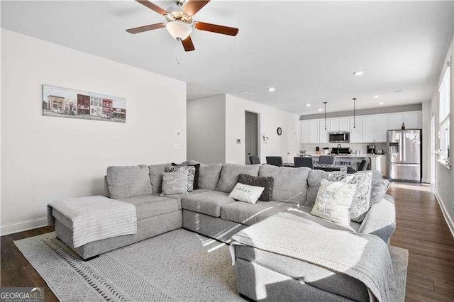 living room featuring dark wood-style flooring, recessed lighting, a ceiling fan, and baseboards