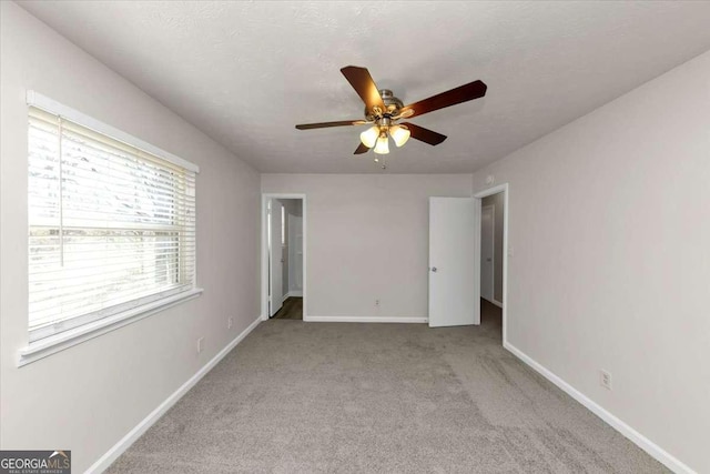 unfurnished bedroom with ceiling fan and light carpet