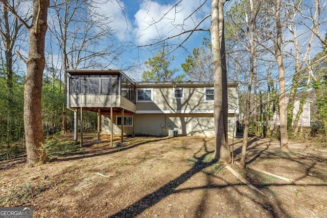 rear view of property featuring a sunroom