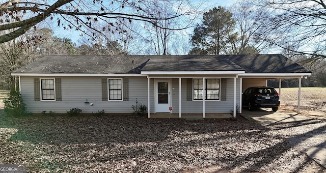 ranch-style house featuring a carport and a porch