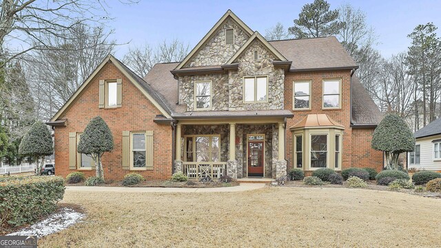 view of front of house featuring a front lawn and covered porch