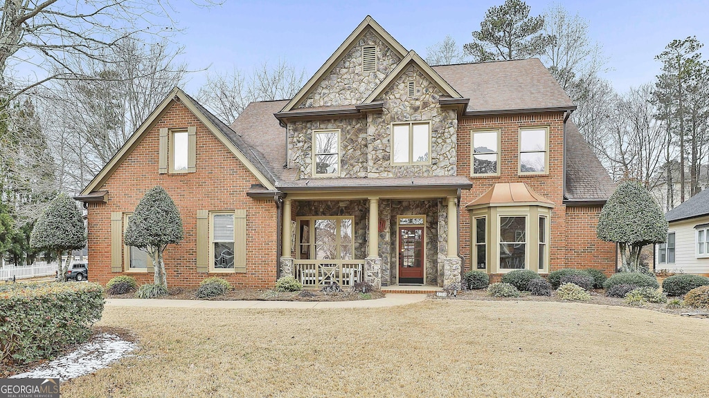 view of front of property with covered porch and a front yard