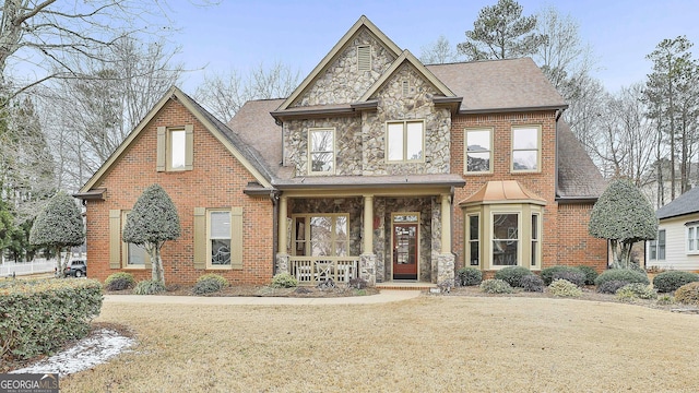 view of front of property with covered porch and a front yard