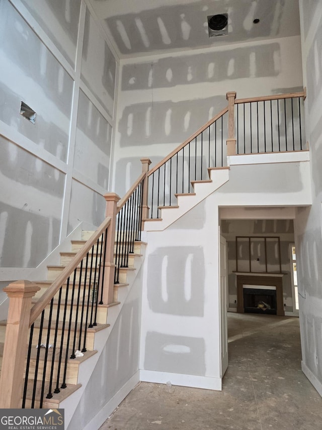 staircase featuring a fireplace