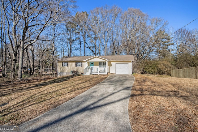 single story home featuring a garage and a front lawn