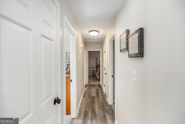 hall featuring a textured ceiling and dark hardwood / wood-style floors