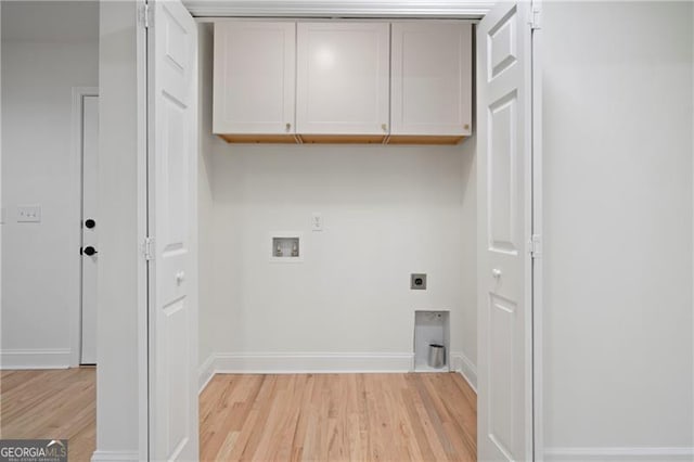 clothes washing area featuring cabinets, electric dryer hookup, hookup for a washing machine, and light wood-type flooring