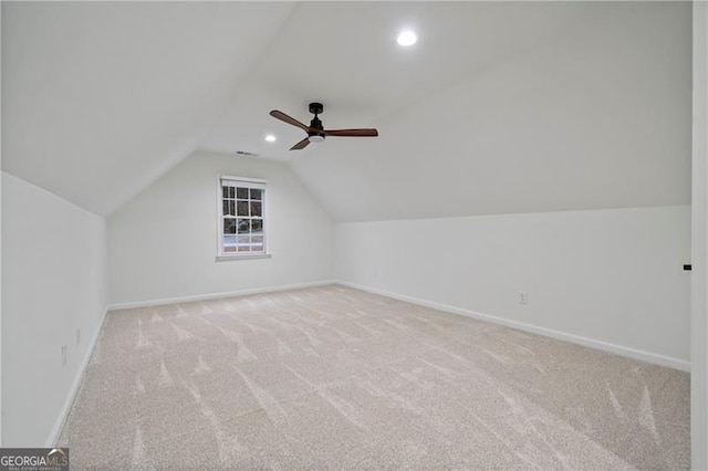 additional living space featuring ceiling fan, light colored carpet, and lofted ceiling