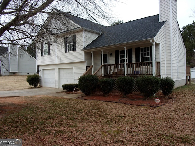 split level home featuring a porch and a garage