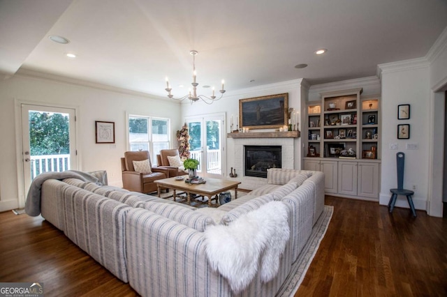 living room with crown molding, dark wood-type flooring, and a brick fireplace