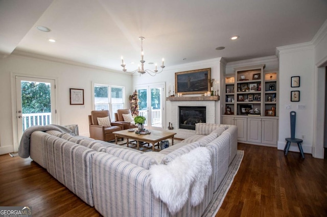 105 Fuller Dr, Carrollton, GA 30117 - living area featuring dark wood-style flooring, a notable chandelier, crown molding, recessed lighting, and a glass covered fireplace