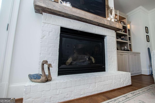 105 Fuller Dr, Carrollton, GA 30117 - interior details featuring a brick fireplace, ornamental molding, and wood finished floors