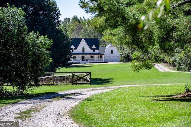 surrounding community featuring a barn, fence, an outbuilding, and a yard