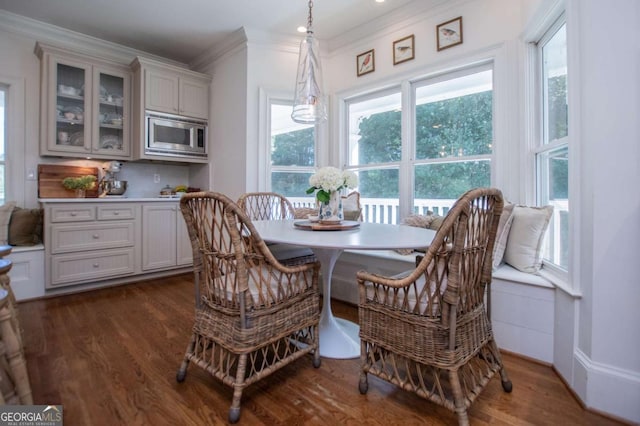 dining room with dark hardwood / wood-style flooring and ornamental molding