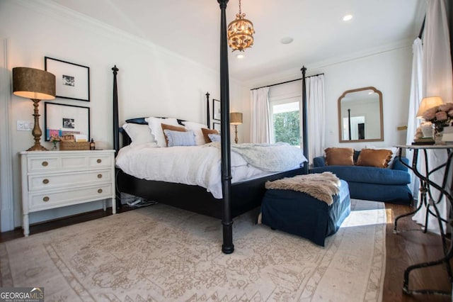 bedroom featuring light hardwood / wood-style floors and ornamental molding